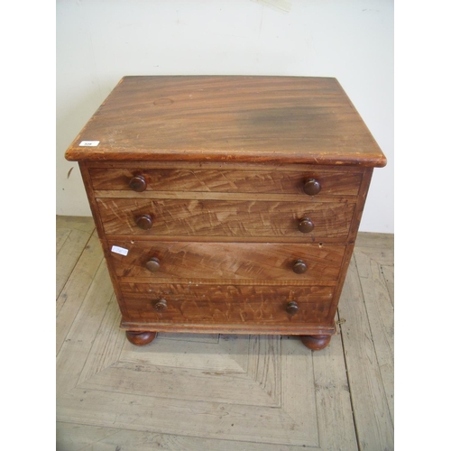 400 - Victorian pine commode in the form of a four drawer chest on turned supports (64cm x 48cm x 71cm)