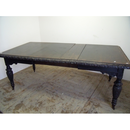 459 - Victorian dark oak extending dining table with two additional leaves and carved border detail, on tu... 