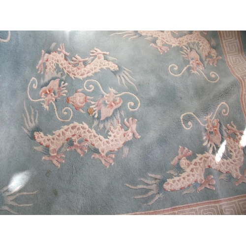 461 - Blue ground Chinese washed woollen rug decorated with dragons (200cm in length)