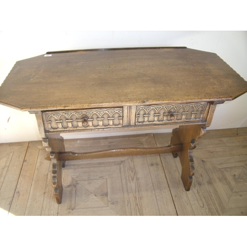 462 - Quality oak reproduction style two drawer side table with shaped top above two carved drawers and cr... 