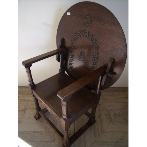 517 - Oak monks style chair with circular tilt top/back with carved detail