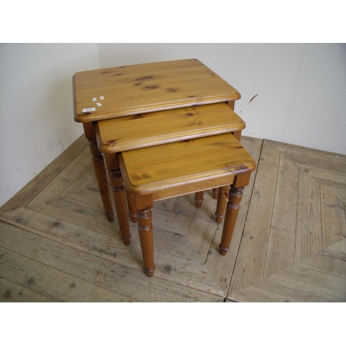 373 - Nest of three graduating pine occasional tables on turned supports and a rectangular pine two tier o... 
