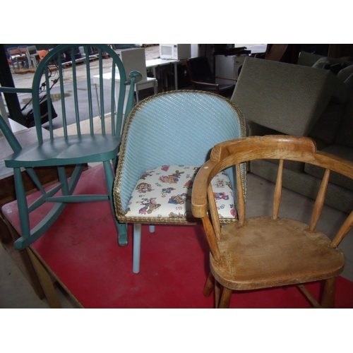 384 - Painted Ercol stick back child's rocking chair, a small child's Lloyd Loom type armchair and another... 