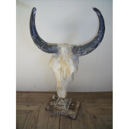 39 - Composite style wildebeest skull on rectangular base stand (87cm high)