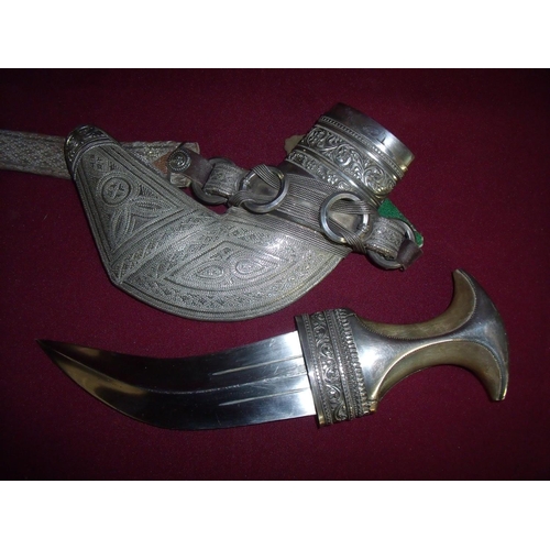 108 - Fine quality Omani Jambiya knife with rhino horn hilt and original silver braid belt, the hilt and s... 