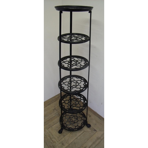 88 - Cast metal six tier graduating pan stand on lion paw feet (122cm high)