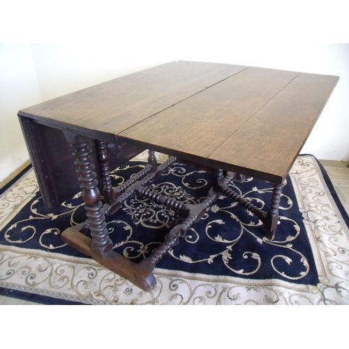 412 - 18th/19th C oak drop leaf table with later heavy planked top, on unusual barley twist base with cros... 