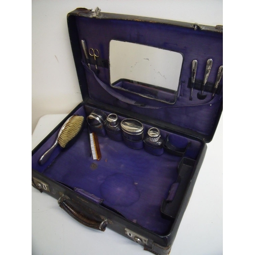 10 - Leather bound travelling case with a selection of various silver plated accessories including manicu... 