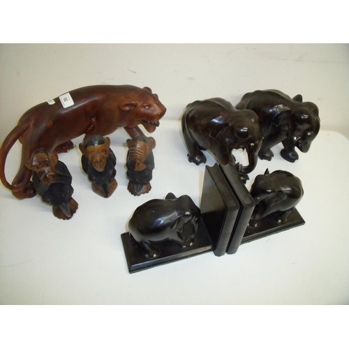 30 - Carved hardwood model of a panther, a pair of carved ebony bookends, a pair of carved wooden elephan... 