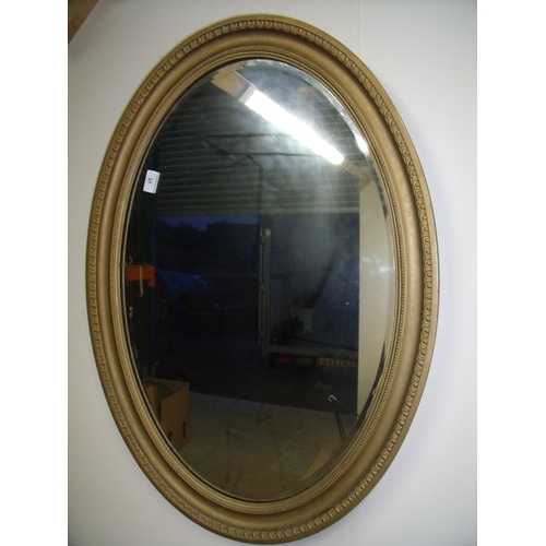 37 - Early 20th C oval gilt framed bevelled edge wall mirror (86.5cm x 61.5cm)