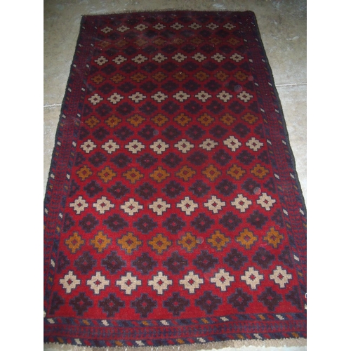 397 - Old red ground Baluchi rug (180cm x 106cm)