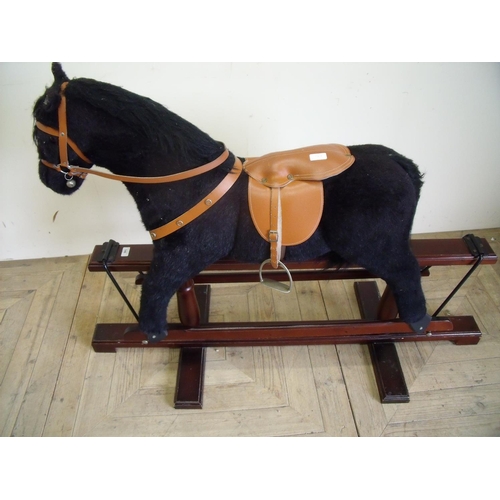 43 - Upholstered modern style rocking horse on wooden swing base