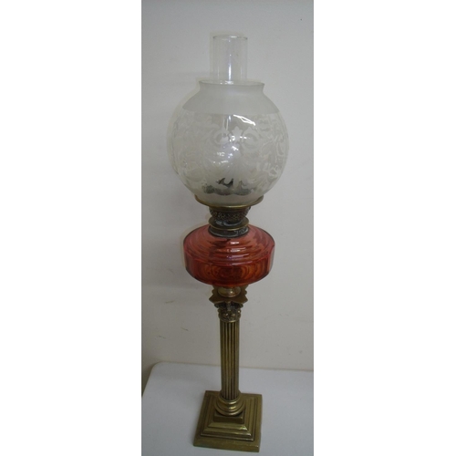 116 - Brass Corinthian column oil lamp with red glass reservoir and etched shade (80cm high)