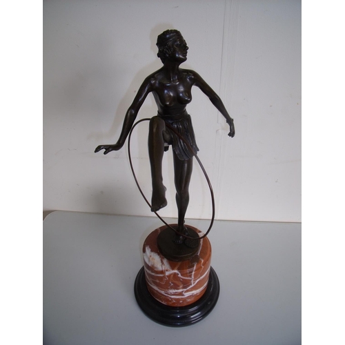 128 - 1920s style bronze figure of a semi-clad dancing girl with hoop, mounted on circular stepped marble ... 