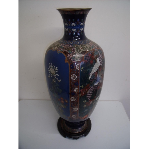 107 - Extremely large Cloisonné vase with panels of birds and floral detail, with flared rim, on hardwood ... 