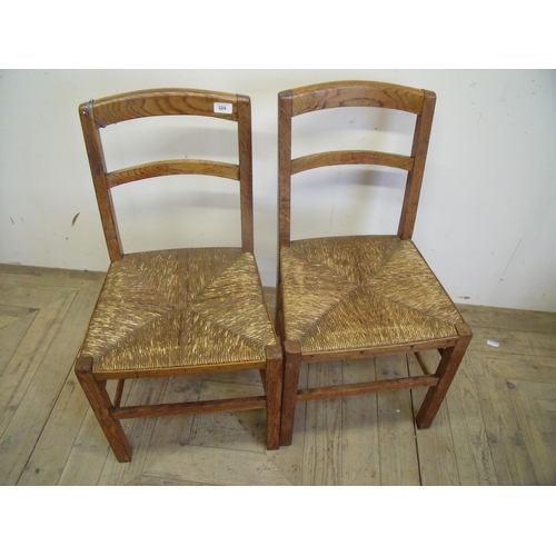 324 - Pair of early 20th C light oak Heals of London chairs with rush work seats and inset Ivorine Heals o... 