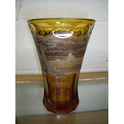 95 - Bohemian style amber glass vase with gilt rim, multi-faceted detail and central panel depicting trav... 