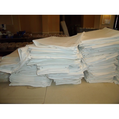 36 - Two large piles of table linen/table clothes