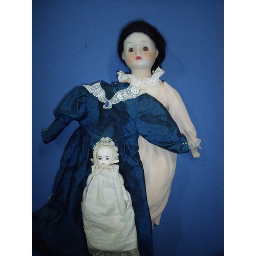 178 - Vintage porcelain head doll with two dresses including blue silk work dress and another porcelain he... 