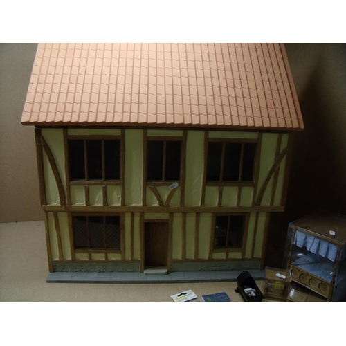 154 - Well constructed 2 storey dolls house with oak timber braced walls and associated furniture