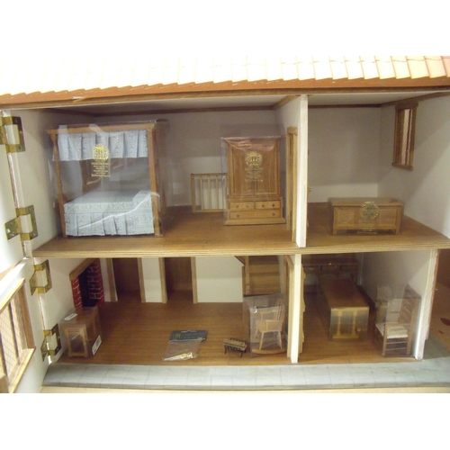 154 - Well constructed 2 storey dolls house with oak timber braced walls and associated furniture