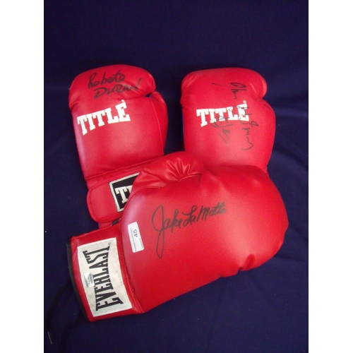 72 - Signed Title red left handed boxing glove signed by Robeto Duran, a right handed boxing glove signed... 