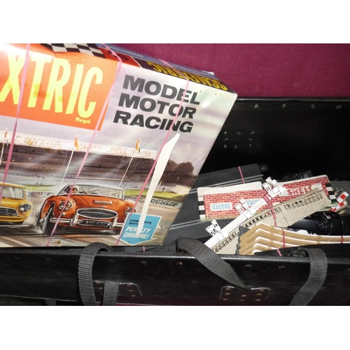 151 - A boxed Scalextric set No 65 with various accessories and a packing trunk with a large selection of ... 