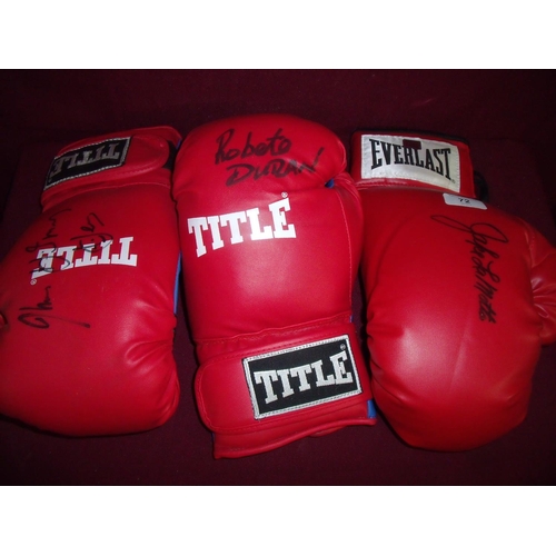 72 - Signed Title red left handed boxing glove signed by Robeto Duran, a right handed boxing glove signed... 