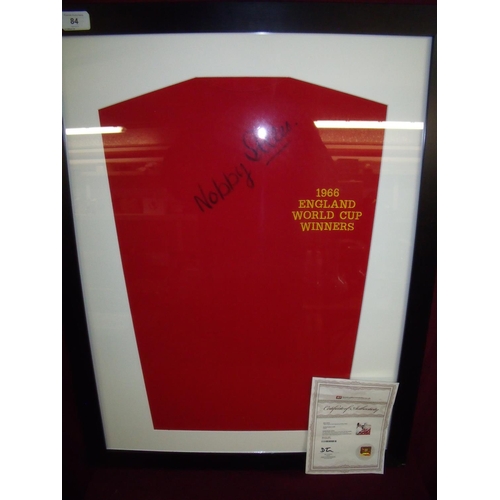 84 - Framed and mounted 1966 England World Cup winners souvenir shirt signed by Nobby Styles with certifi... 