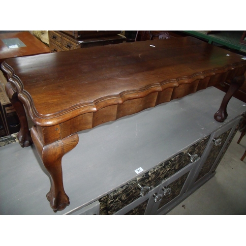 362 - Rectangular walnut coffee table on ball & claw feet (114cm x 46cm)