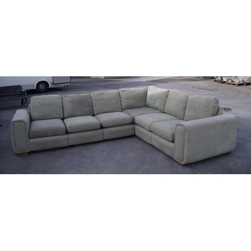 432 - A large corner settee in green pattern chenille fabric (length 310cm x 250cm deep)