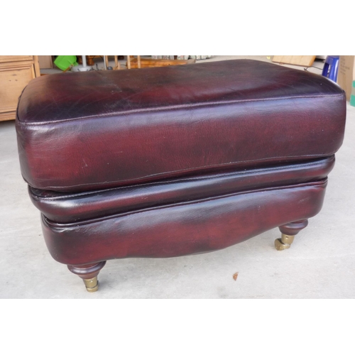 287 - A rectangular red leather footstool on turned supports