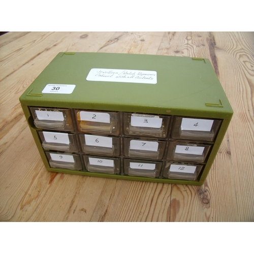 30 - Twelve drawer green plastic cabinet containing various repair parts for watches including various wa... 