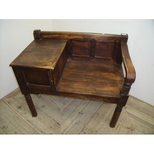 365 - Indian hardwood telephone type table with bench seat and single cupboard door (width 87cm)