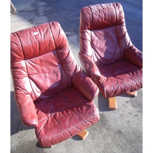 373 - Pair of brown leather swivel lounge chairs