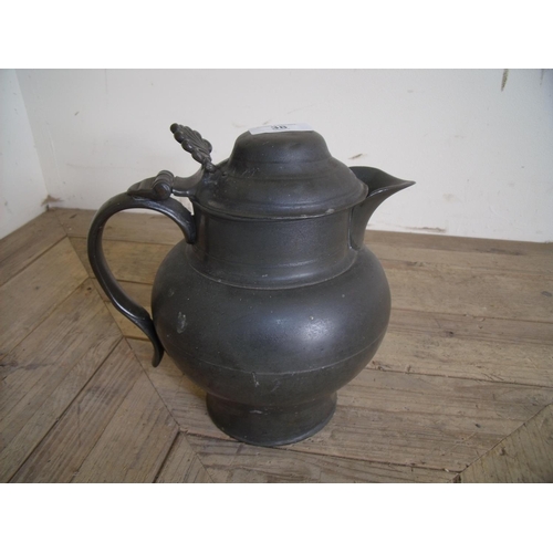 38 - 19th C pewter jug with hinged lid (22cm high)