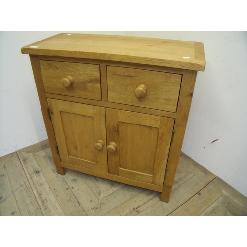 401 - Modern light oak cabinet with two drawers above two panelled cupboard doors (75cm x 34cm x 80cm)