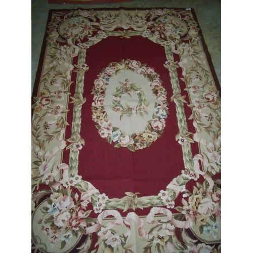423 - Red & beige ground needle point rug (119cm x 179cm)