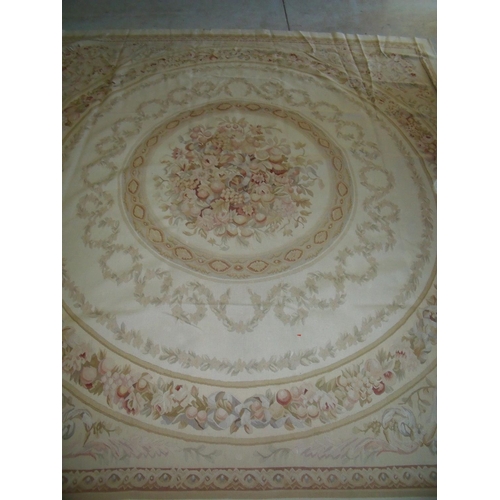 427 - Large beige ground needle point woollen carpet with central circular repeating pattern and floral pa... 