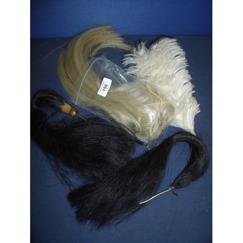 156 - Two lancer cap black horse hair plumes, a selection of white horsehair plumage and a white hackle ty... 