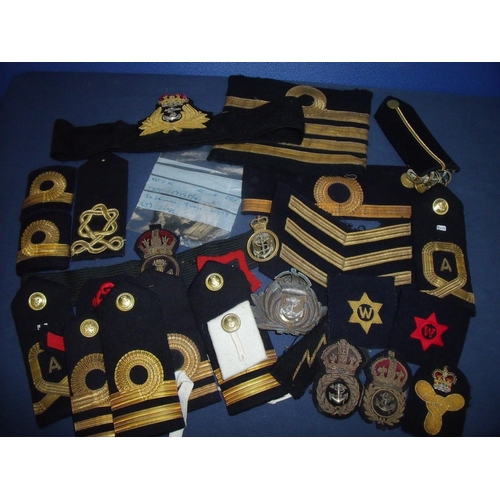 17 - Large collection of naval insignia, mostly embroidered cloth, including epaulettes, cap tallies, emb... 