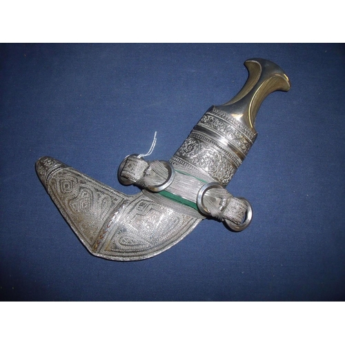 210 - 19th C Omani Jambiya with rhino horn hilt, the hilt and scabbard covered with fine silver decorated ... 