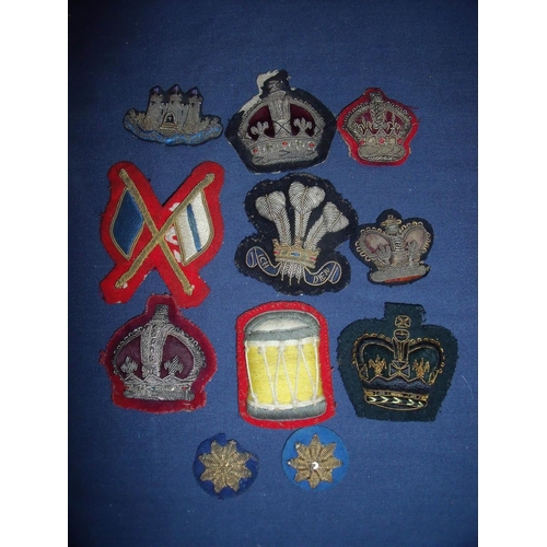 34 - Collection of various assorted embroidered and cloth badges and insignia including various crowns, P... 