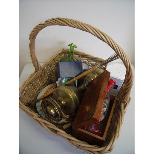57 - Large wicker basket containing a quantity of various assorted items including an oil lamp, boxed gla... 