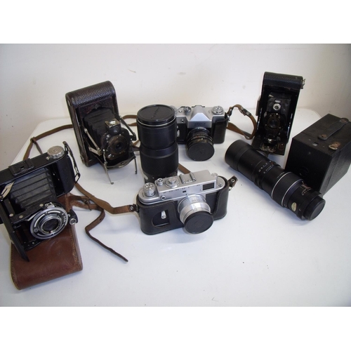 59 - Box containing a quantity of various vintage cameras including Zorki, Zenit-B, folding cameras, boxe... 