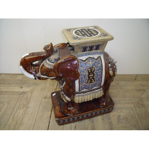 32 - A mottled glazed ceramic elephant stool 
(56 cm high)