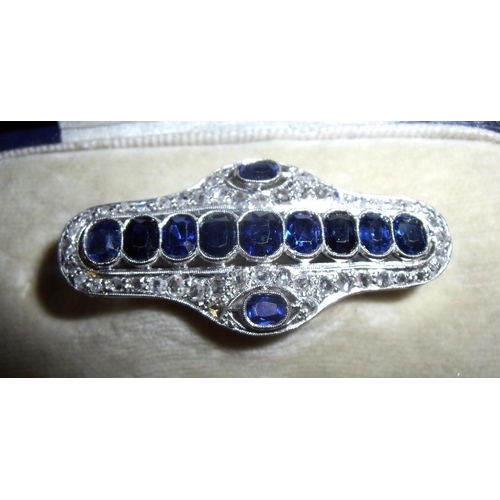 162 - A multi-stone diamond & sapphire rectangular brooch set with eleven faceted sapphires within diamond... 