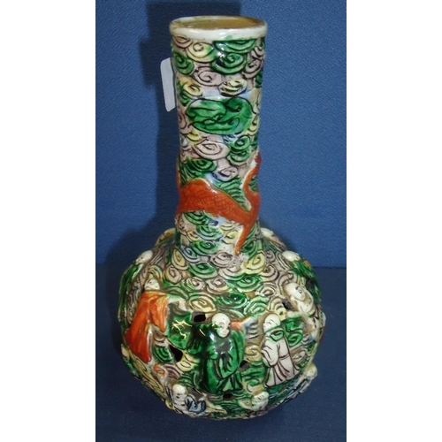 21 - An unusual Japanese bottle neck vase with pierce detail decorated with multiple figures and dragons ... 