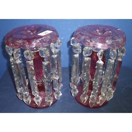 25 - Pair of Victorian cranberry glass lustre candlesticks with clear cut glass drops (25cm high) (1 drop... 