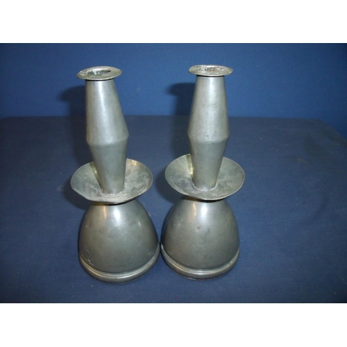 38 - Unusual pair of pewter candlesticks engraved with armorial crest, the under side market 